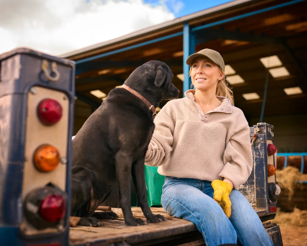 woman with a black labrador
